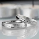 Pair of stainless steel wedding rings with satin silver engraving.