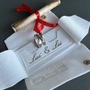 Pair of thin, satin-finished steel engagement rings in silver