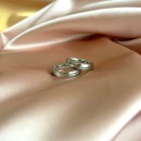 Pair of thin, satin-finished steel engagement rings in silver