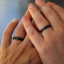 Pair of thin black stainless steel simple bands.