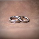 Couple of simple engagement rings made of steel with engraving